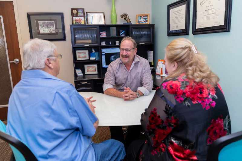 dr leedy discussing dental procedure with patients