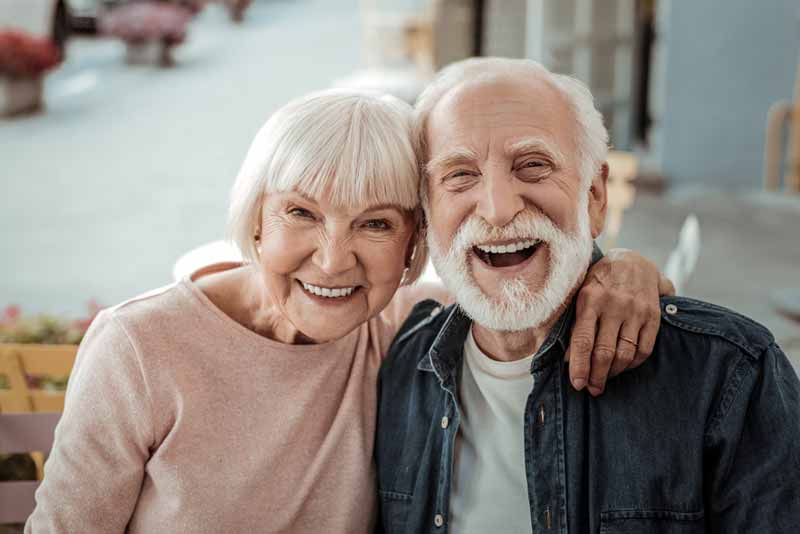 couple smiling after a dental implant procedure