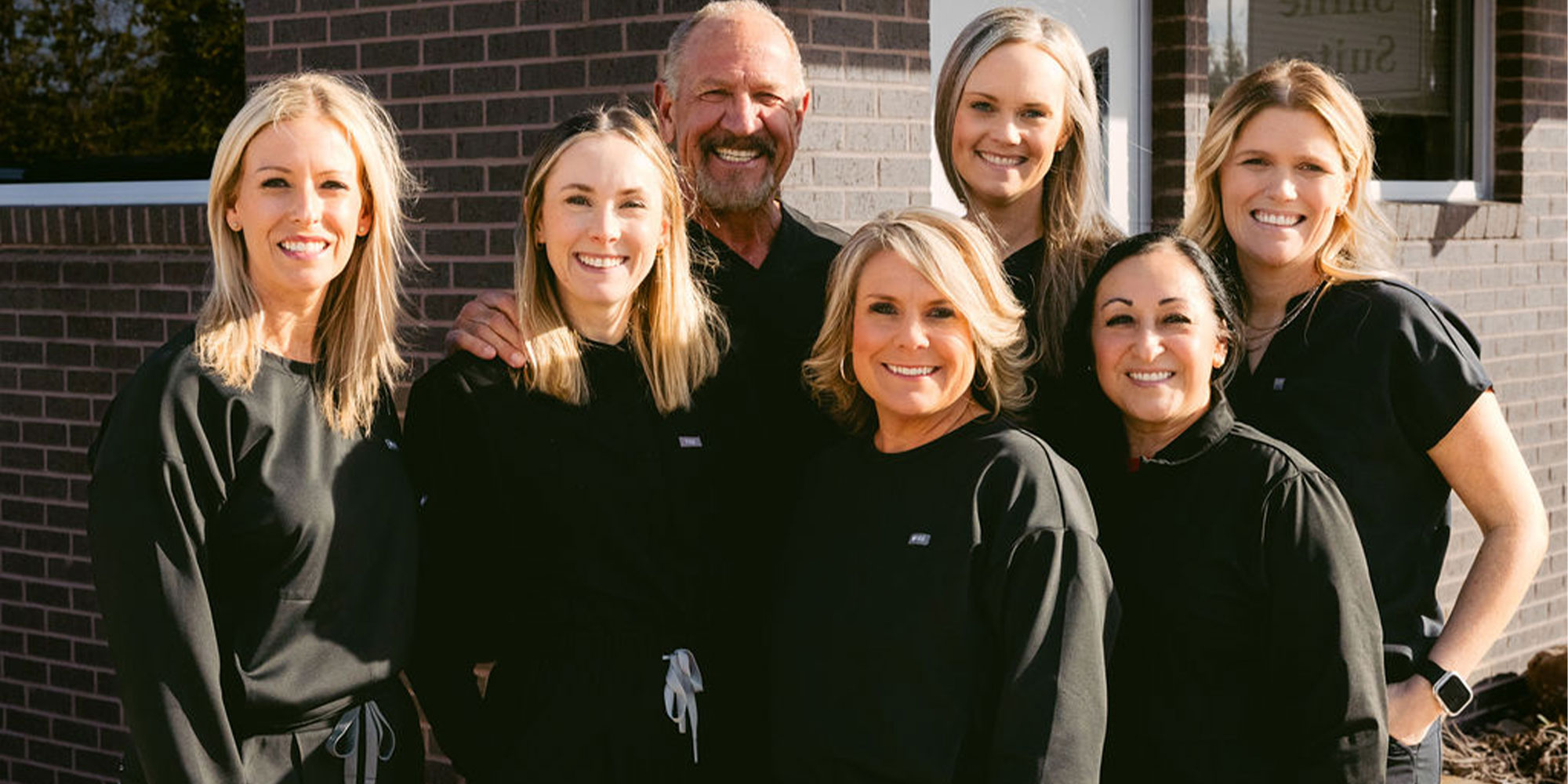 Doctor and his team smiling